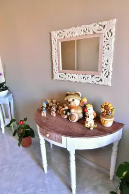 a table with a mirror and stuffed animals on it at Bed and Breakfast Il Girasole in Mondello