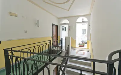 a hallway with a spiral staircase in a building at Palazzo Gallo in Palermo