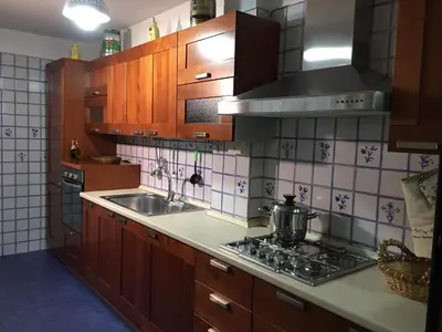 a kitchen with a sink and a stove top oven at Armida House - Mondello in Mondello