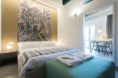 a bedroom with a bed with a painting on the wall at Dietro la Cattedrale in Palermo