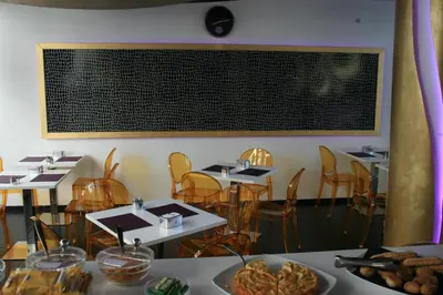 a dining room with tables and chairs and a chalkboard on the wall at Mille e Una Notte in Nuova Gibellina