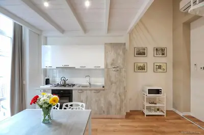 a kitchen with a vase of flowers on a table at Maison Cutò in Palermo