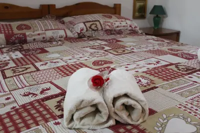 a bed with towels and a rose on it at Da Angelo in Castellammare del Golfo