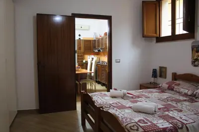 a room with a bed and a kitchen with a kitchen at Da Angelo in Castellammare del Golfo