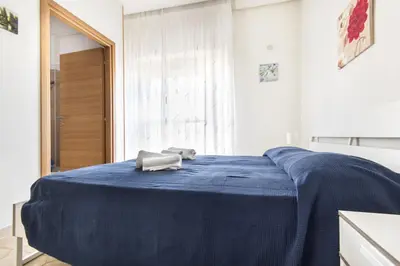 a bedroom with a blue bed with a towel on it at Apartments Bed Abate in Villabate
