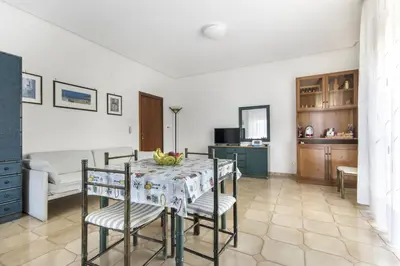 a kitchen and dining room with a table and chairs at Apartments Bed Abate in Villabate