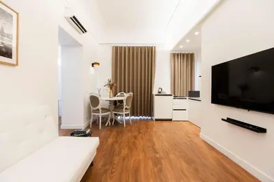 a living room with a large television and a table at Palazzo del Poeta - Dimora Contemporanea in Palermo