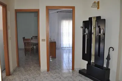 a living room with a refrigerator and a dining room at Summerhouse Sagana in Monreale