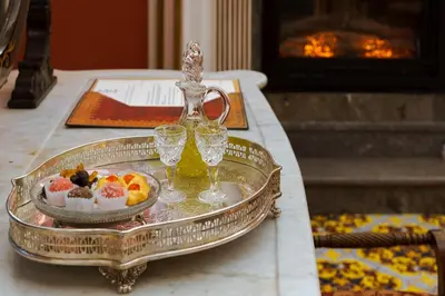 a silver tray with desserts and glasses on a table at Palazzo Arone dei Baroni di Valentino in Palermo