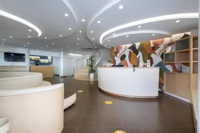 a lobby with a reception desk in a building at Alaba Hotel in San Vito lo Capo