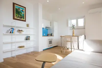 a white living room with a table and a couch at Villa Mallandrino in Mondello