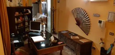 a room with a desk with a computer and a fan at Cavour Il Conte Camillo in Palermo