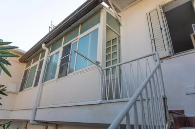 a balcony of a house with glass doors at Casa BabbaLuciana in Mondello