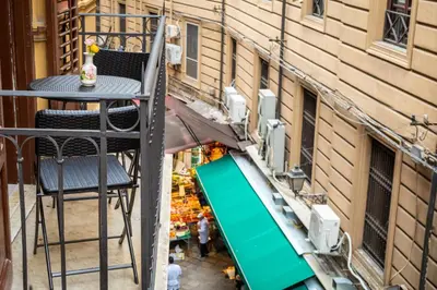 an overhead view of a table and chair on a balcony at B&B Opera dei Pupi in Palermo