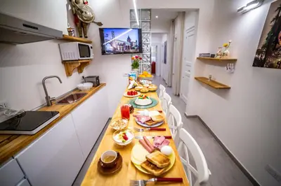 a kitchen with a long table with food on it at B&B Opera dei Pupi in Palermo