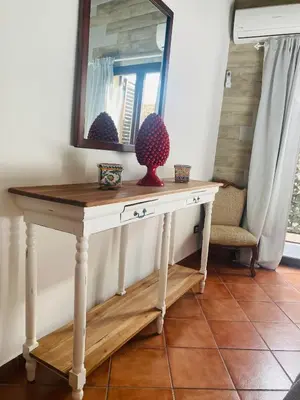 a dressing table with a mirror and a vase on it at Palazzo Rea in Palermo