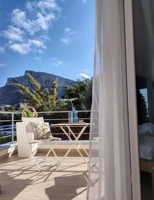 a balcony with a chair and a view of a mountain at Zabbàra B&B in Terrasini
