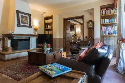 a living room with a leather couch and a fireplace at Villa Gabriella - Mondello in Mondello
