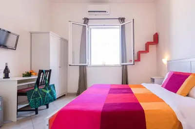 a bedroom with a bed with a colorful blanket at Casa da Silvia in Palermo