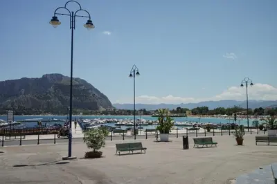 a park with benches and a harbor with boats at Casa da Silvia in Palermo