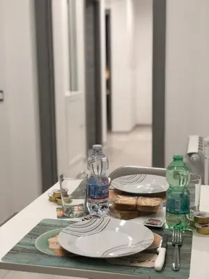 a table with plates and water bottles on a table at STABILE139 in Palermo