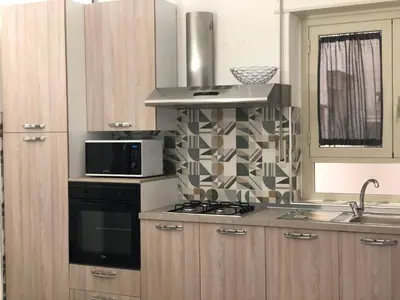 a kitchen with a stove and a microwave at STABILE139 in Palermo