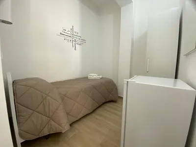a room with a bed in the corner of a room at IN CENTRO ROOMS Vicino Cefalù SELF-CHEK-IN in Campofelice di Roccella