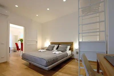 a bedroom with a bed and a desk and a table at Maqueda331 in Palermo