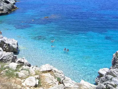 a group of people swimming in the blue water at CIELO D' ALCAMO Palazzo Adamo in Alcamo