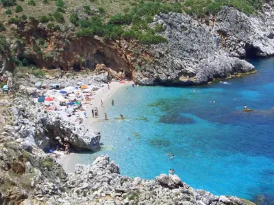 a group of people on a beach in the water at CIELO D' ALCAMO Palazzo Adamo in Alcamo