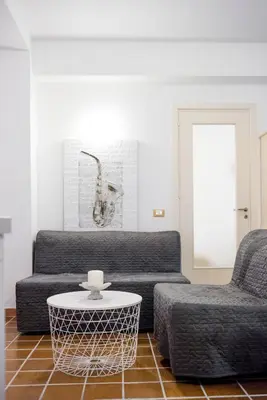 a living room with a couch and a table at Casa Vela Bianca Mondello Addaura in Palermo