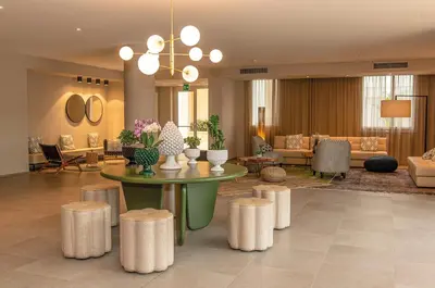 a lobby with a table and stools in a room at Mangia's Himera Resort in Campofelice di Roccella