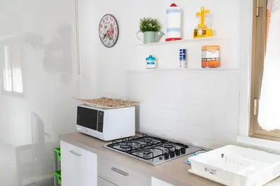 a kitchen with a stove and a microwave on a counter at Villa Claudia e Simone in Carini