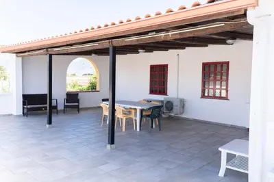 a patio with a table and chairs under awning at Villa Claudia e Simone in Carini
