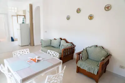 a living room with a table and chairs at Villa Claudia e Simone in Carini