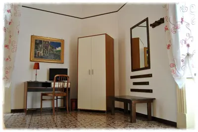 a room with a desk and a chair and a mirror at Bed and Breakfast D'Angelo in Palermo