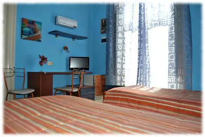 a bedroom with a bed and a desk and a television at Bed and Breakfast D'Angelo in Palermo