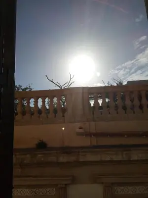 a view of the sun from the top of a balcony at I Cavalieri di Malta in Palermo
