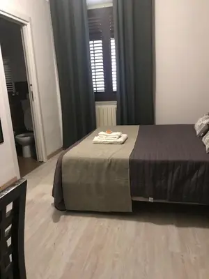a bedroom with a bed with a towel on it at BONORUM in Palermo