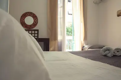 a bedroom with a bed and a window and a mirror at BONORUM in Palermo