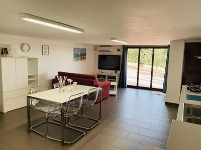 a living room with a table and a couch at La Caletta Casa Vacanze, PRIVATE POOL in Terrasini