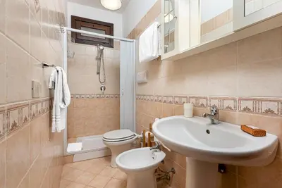 a bathroom with a sink and a toilet and a sink at Carlottas Home in San Vito lo Capo