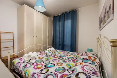 a bedroom with a bed with a colorful comforter at Carlottas Home in San Vito lo Capo