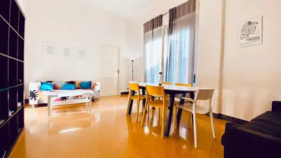 a living room with a table and chairs and a couch at Mamamia #Politeama in Palermo