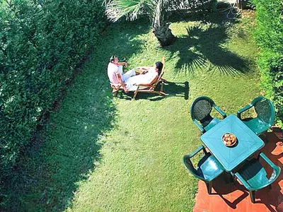 two people sitting in lawn chairs in the grass at Residence in Sicily near Himera & Madonie Park in Buonfornello