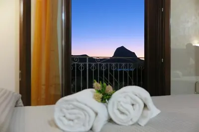 a pile of towels sitting on top of a bed at Trigrana Vacanze Hotel in Castelluzzo
