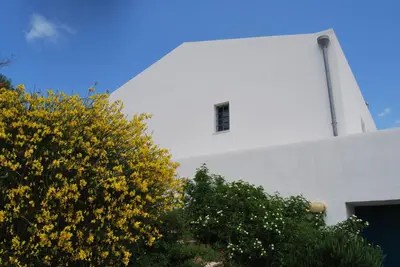 a swimming pool with two white pillows next to a building at casa zabbara in Balestrate