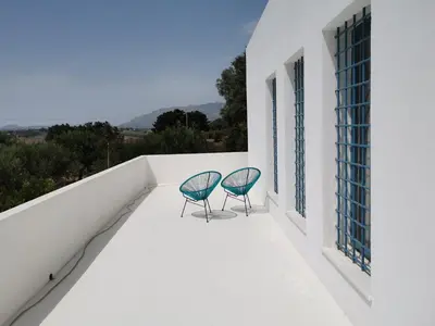 a bedroom with a bed and a large window at casa zabbara in Balestrate