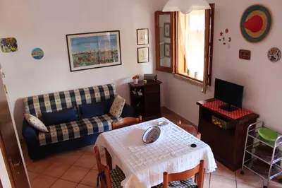 a living room with a couch and a table at Villetta con giardino Mandarino Macari in Macari