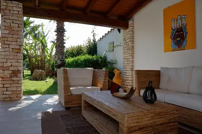 a living room with a couch and a table at Villa Araucaria in Partinico